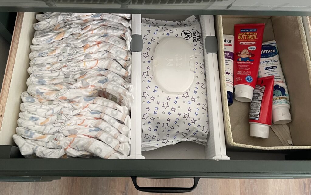 Photo of a dresser drawer with diapers, wipes, dividers, and diapers creams
