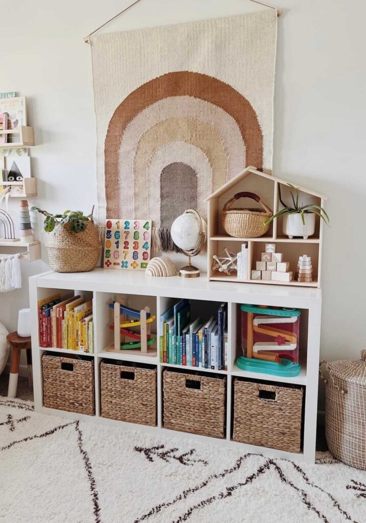 Nursery cube dresser that is storing books, bins, and toys.