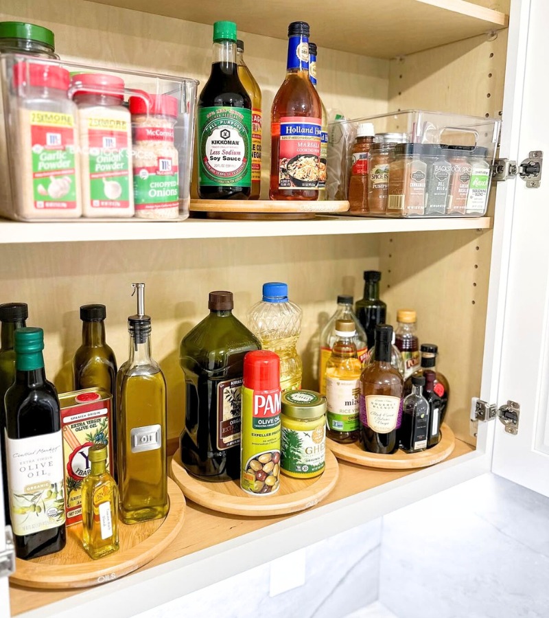 White cabinet pantry with pantry items on several lazy susans