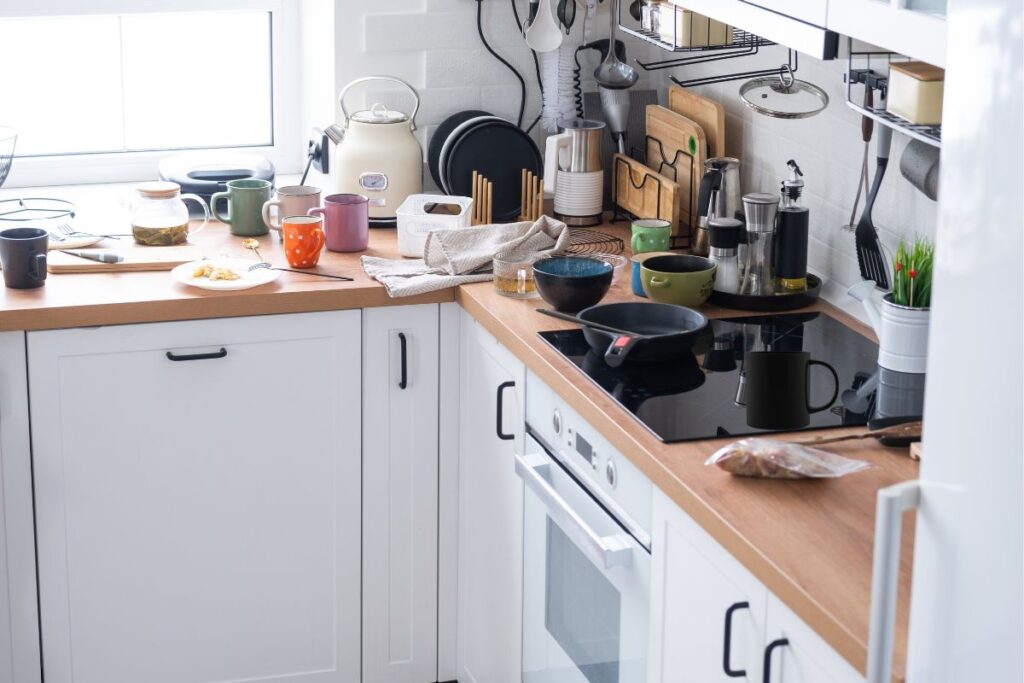 Cluttered kitchen with kitchen items all on the counter