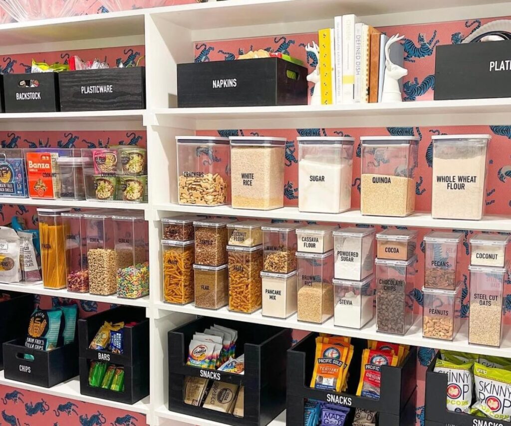 A large pantry with pantry items in bins all labeled