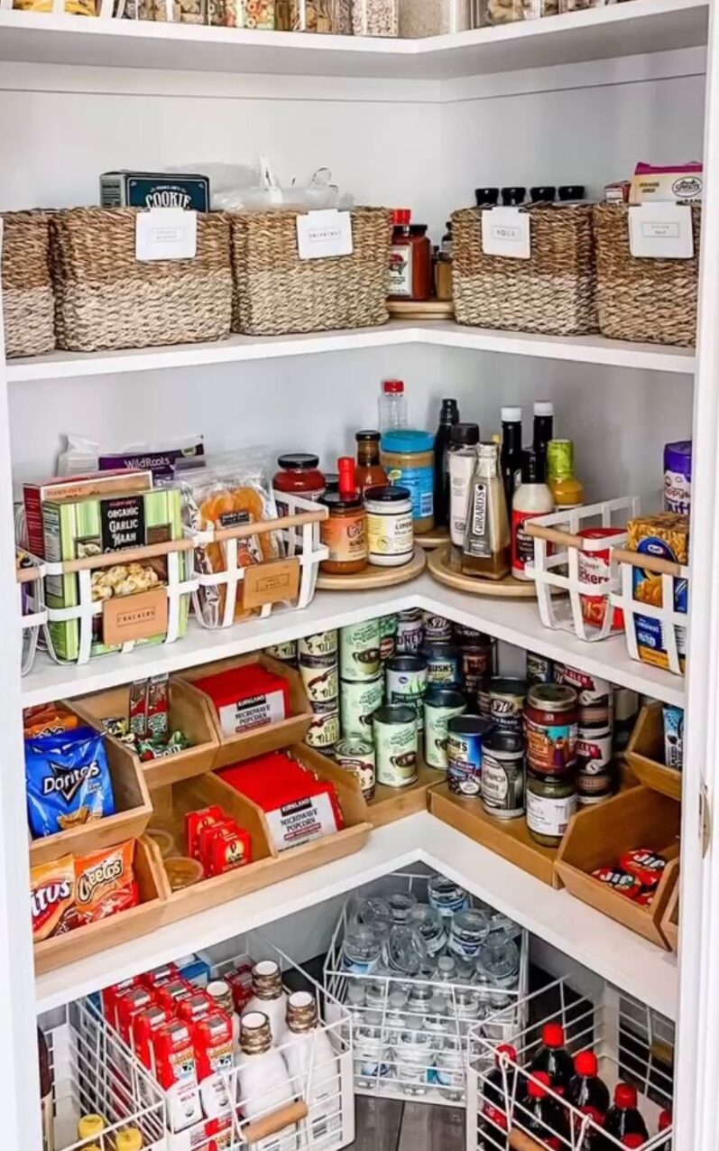 Corner pantry that's utilizing all storage space with bins and lazy susans.