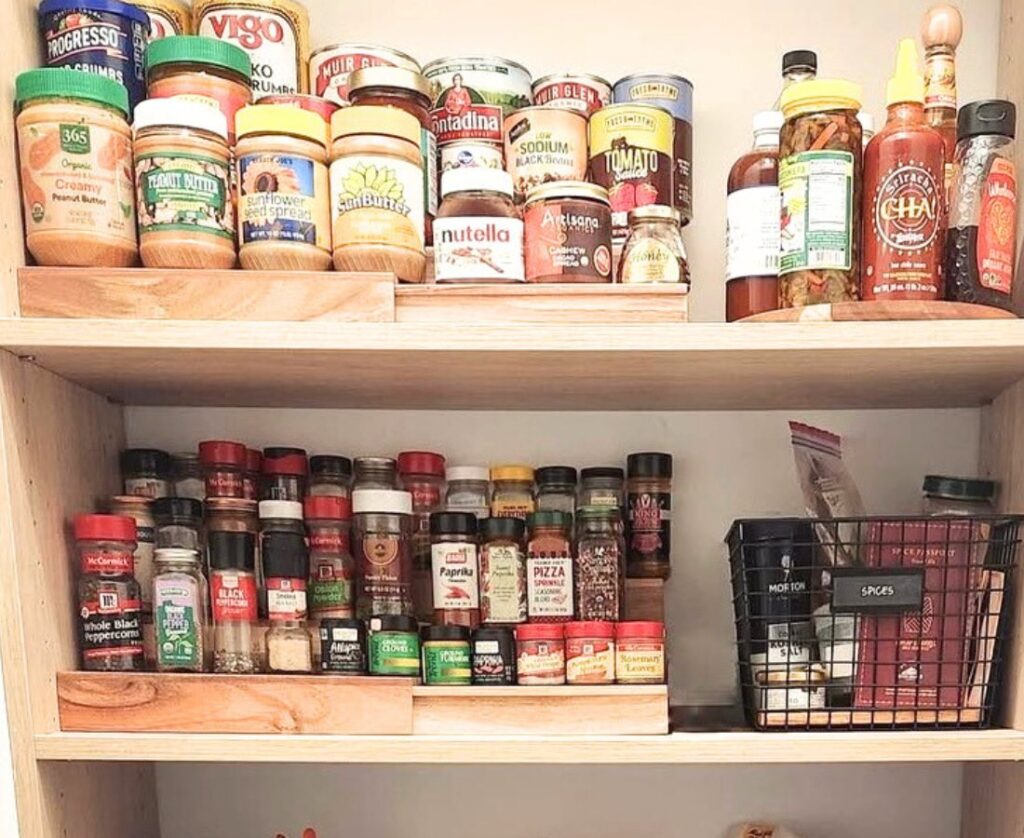 Tiered can organizers with cans on them stored in a pantry