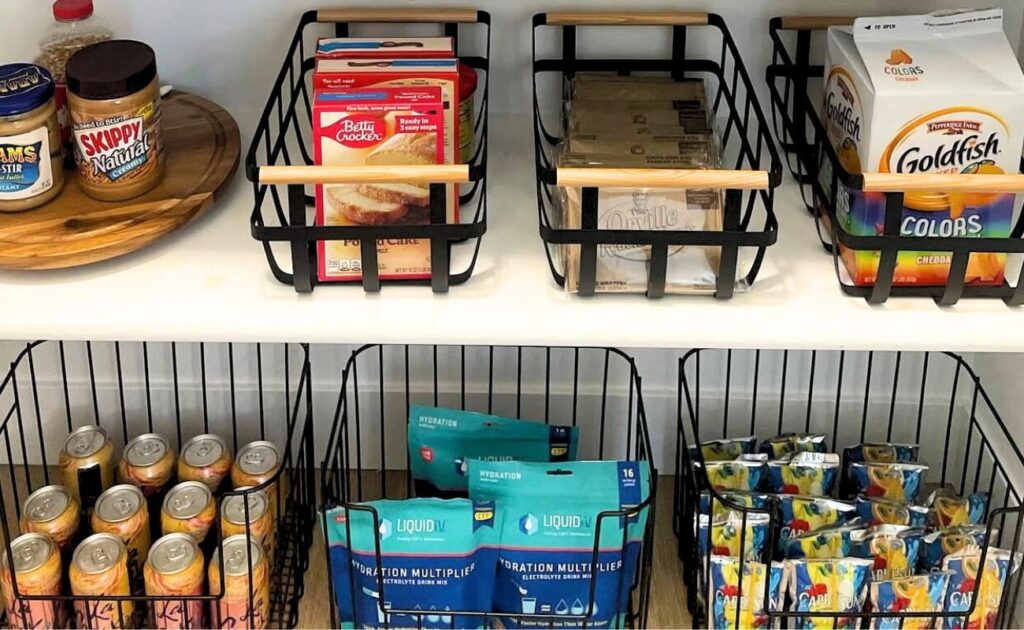 Items organized in a pantry with black wire baskets