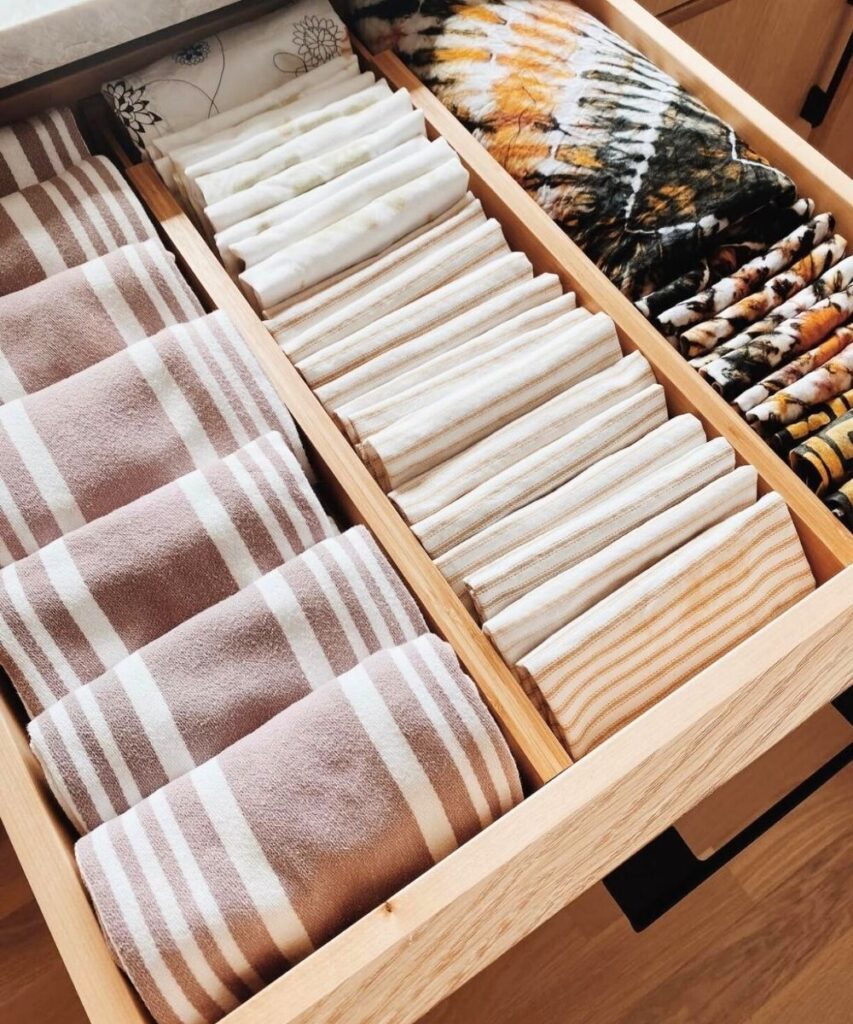 Dish towels folded nicely and organized in a kitchen drawer 