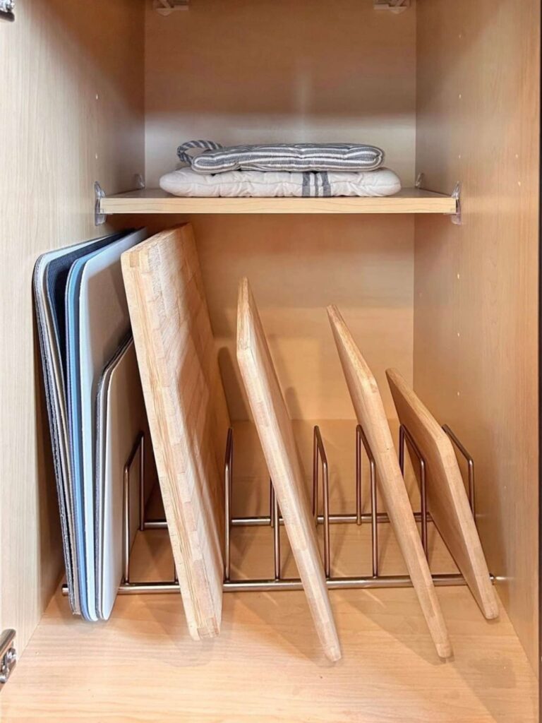 Cutting boards organized on a cutting board rack in a kitchen cabinet 