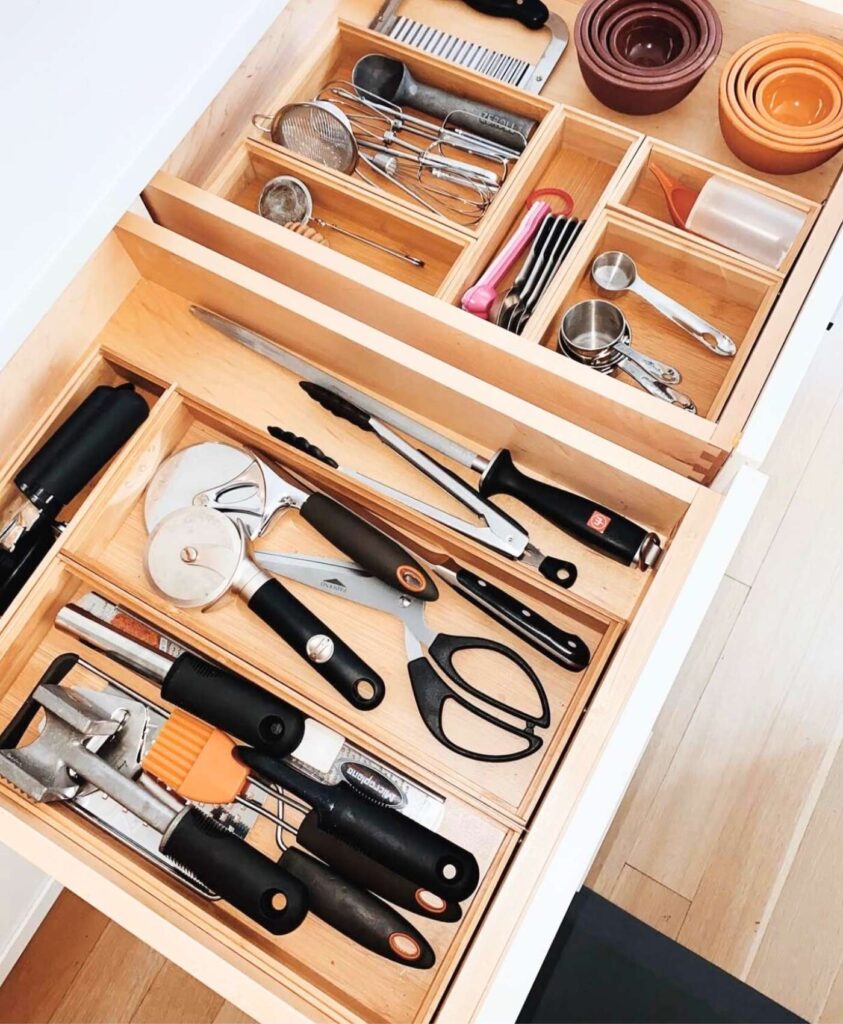 Cooking utensil drawer organized with wooden drawer organizers