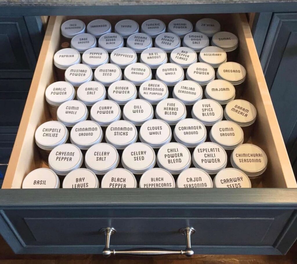 Spices organized in a drawer with the tops labeled