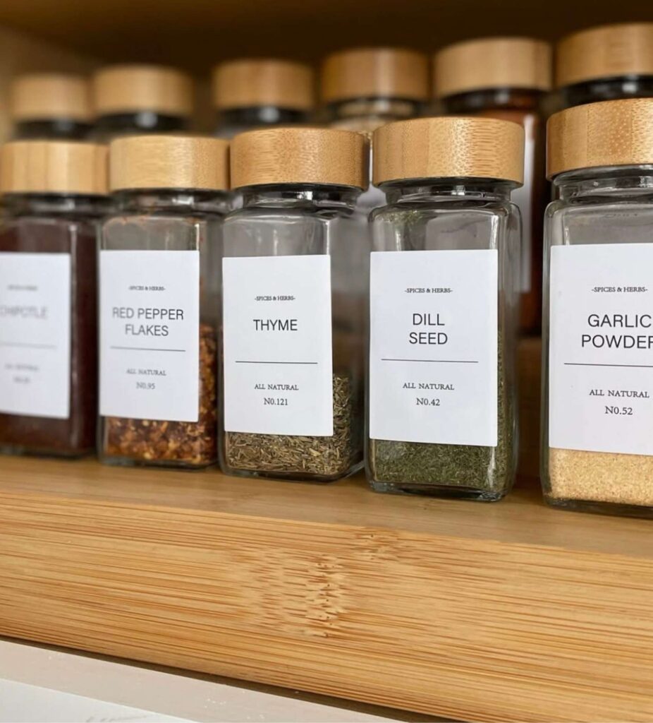 Kitchen spice jars with modern white labels on a shelf