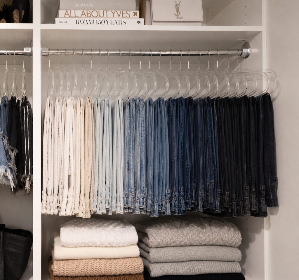 A closet categorized by color and type of clothing. 