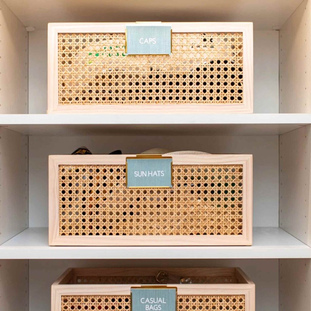 Decorative bins organized neatly on bedroom closet shelf