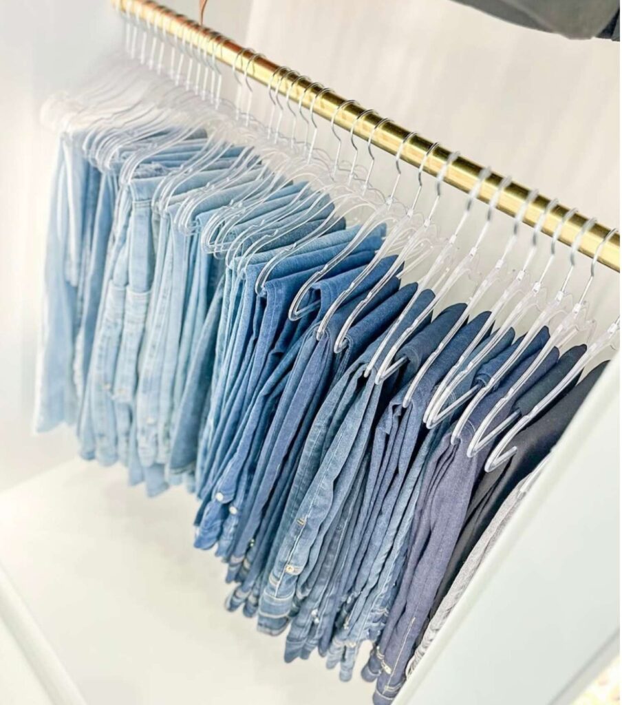 Jeans hanging organized in a bedroom closet