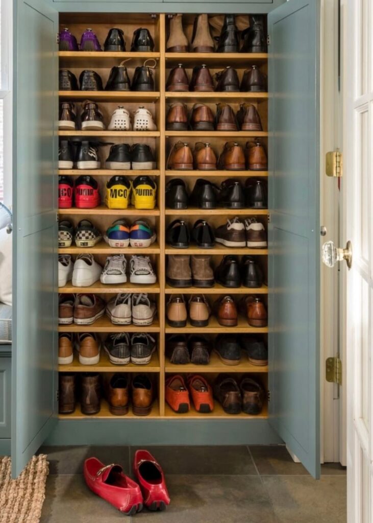 Shoe cabinet storage with shoes organized on shelves 