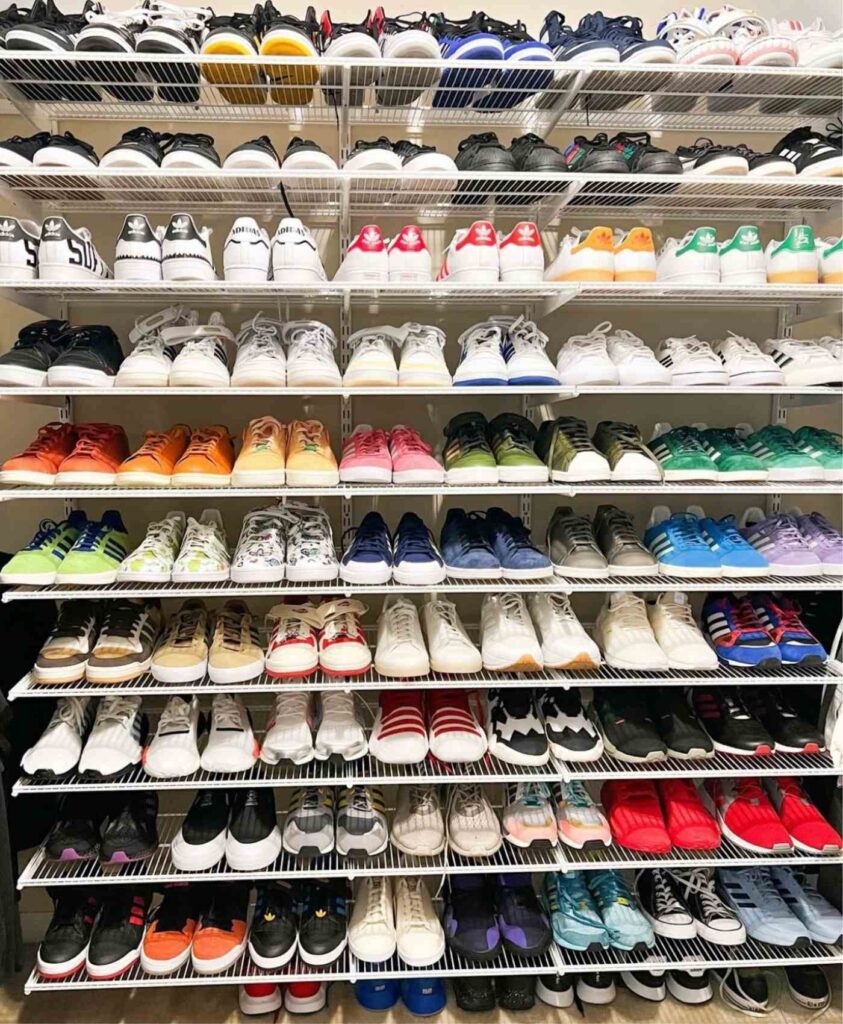 Sneakers organized on white wire rack very neatly