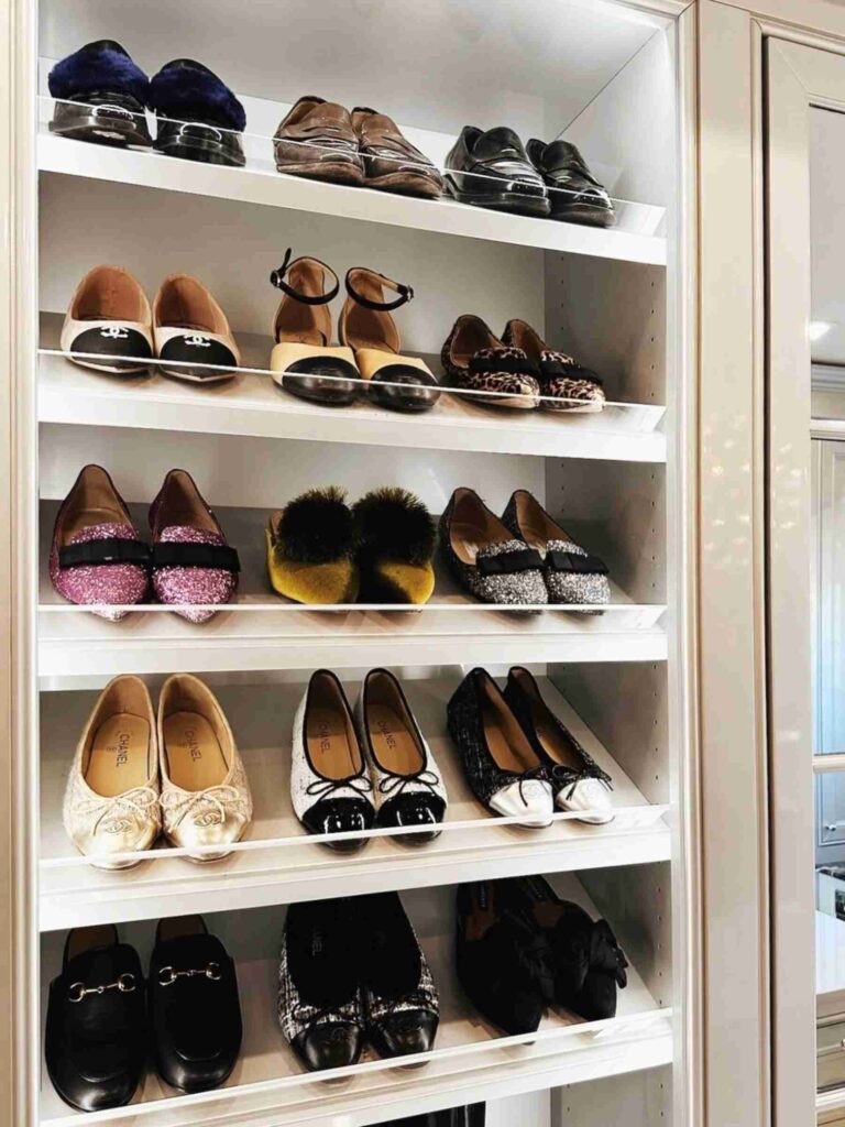 Slanted wall shoe storage in a walk-in closet 