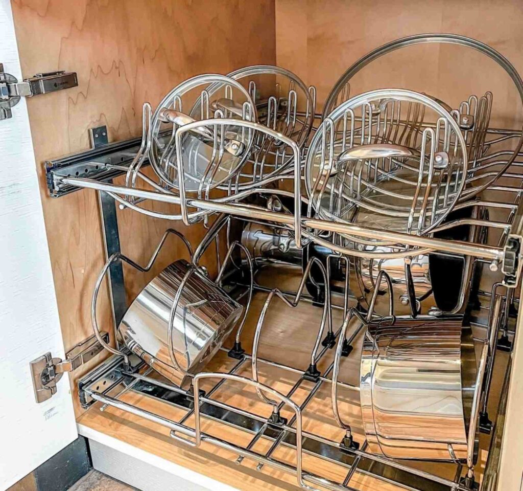 Pots and pans organized on sliding cabinet wire rack