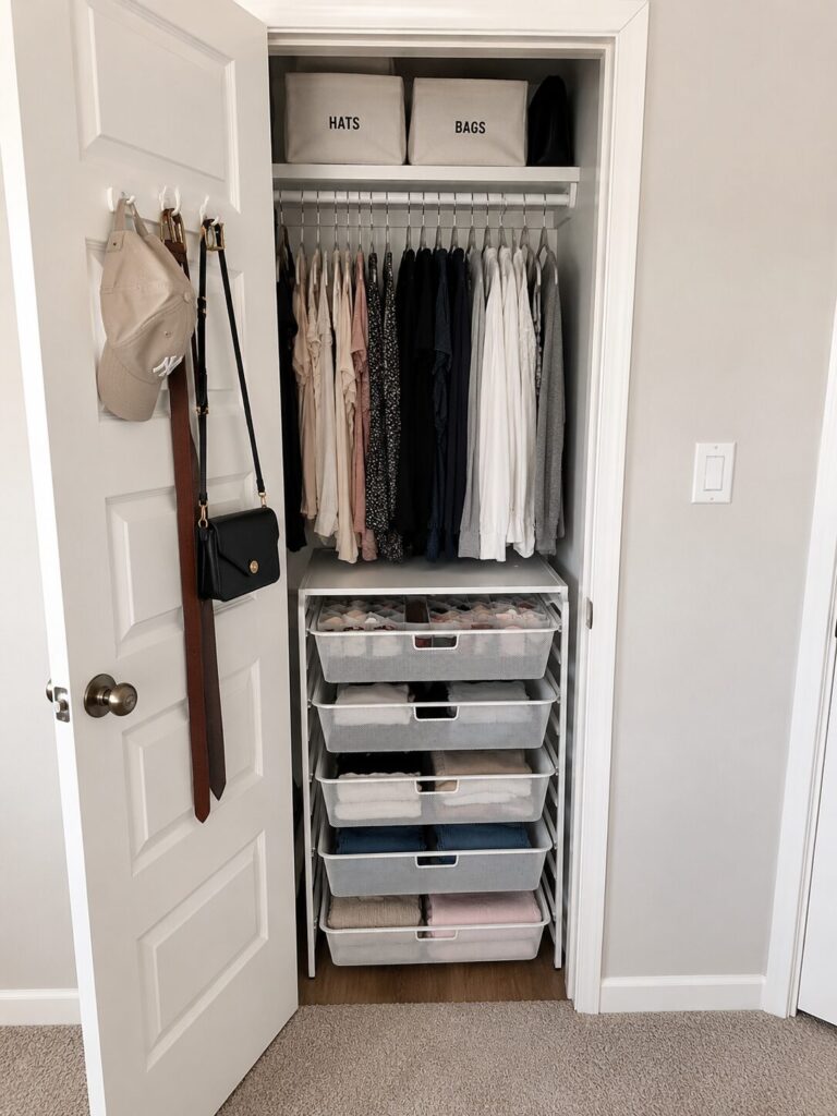 Freestanding closet drawer organizer on the bottom of a small closet